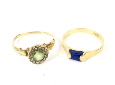 An early 20th century gold, peridot and half-pearl cluster ring and a modern lapis lazuli ring.