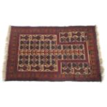 A Caucasus prayer rug with repetative medallions on a beige ground the main border decorated with