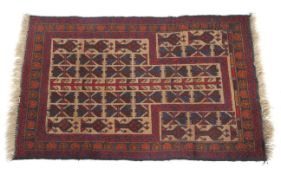 A Caucasus prayer rug with repetative medallions on a beige ground the main border decorated with