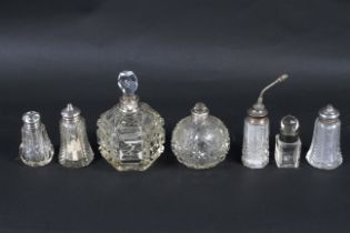 A group of silver and white metal mounted cut glass bottles.