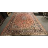 A large Persian style woollen carpet.