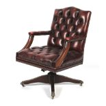 A 20th century leatherette Captain's buttonback swivel armchair.