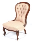 A Victorian mahogany button back chair.