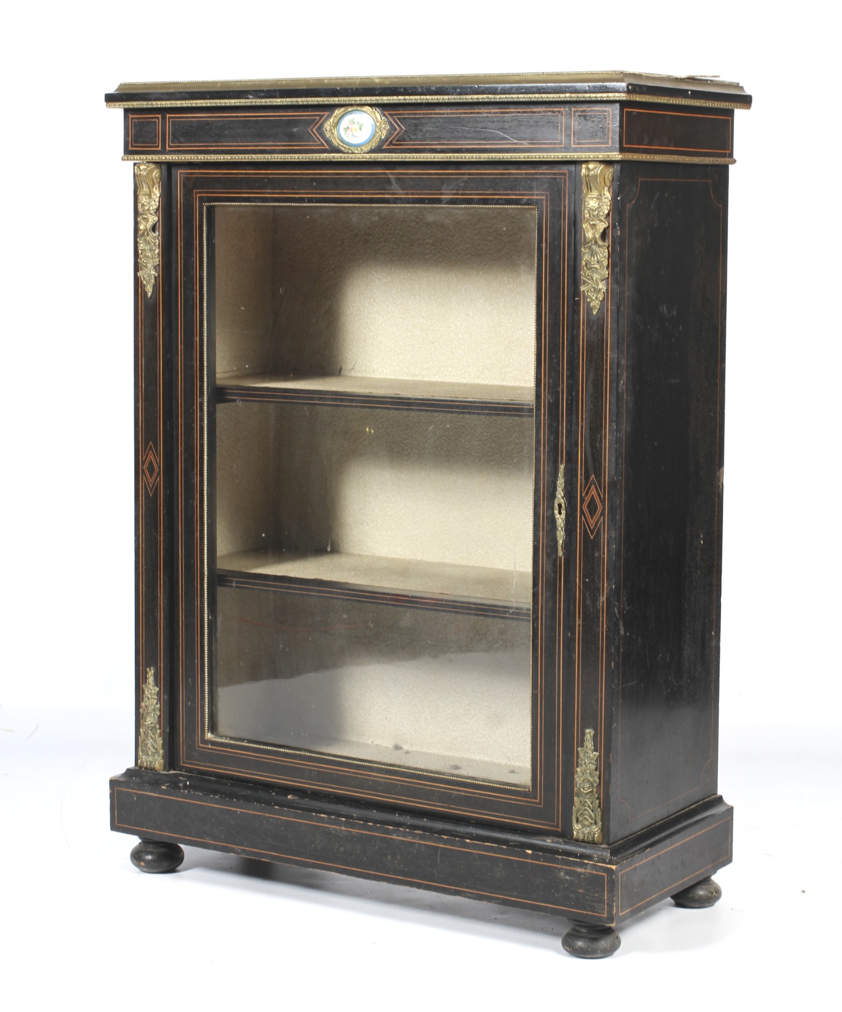 A 19th Century French ebonised gilt-metal mounted pier cabinet.
