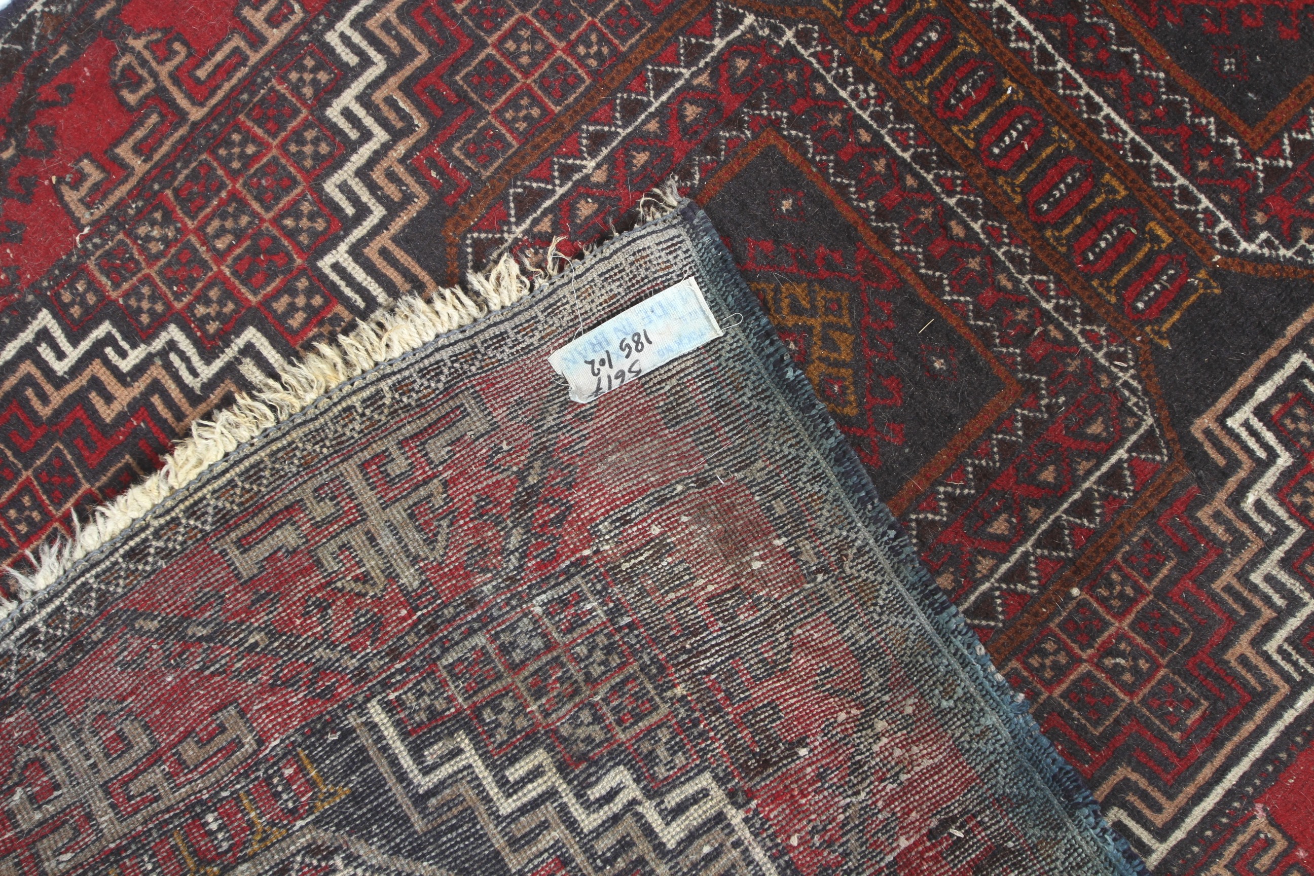 A 20th century Iranian wool rug. - Image 3 of 3