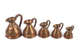 A collection of Victorian copper jugs in sizes.