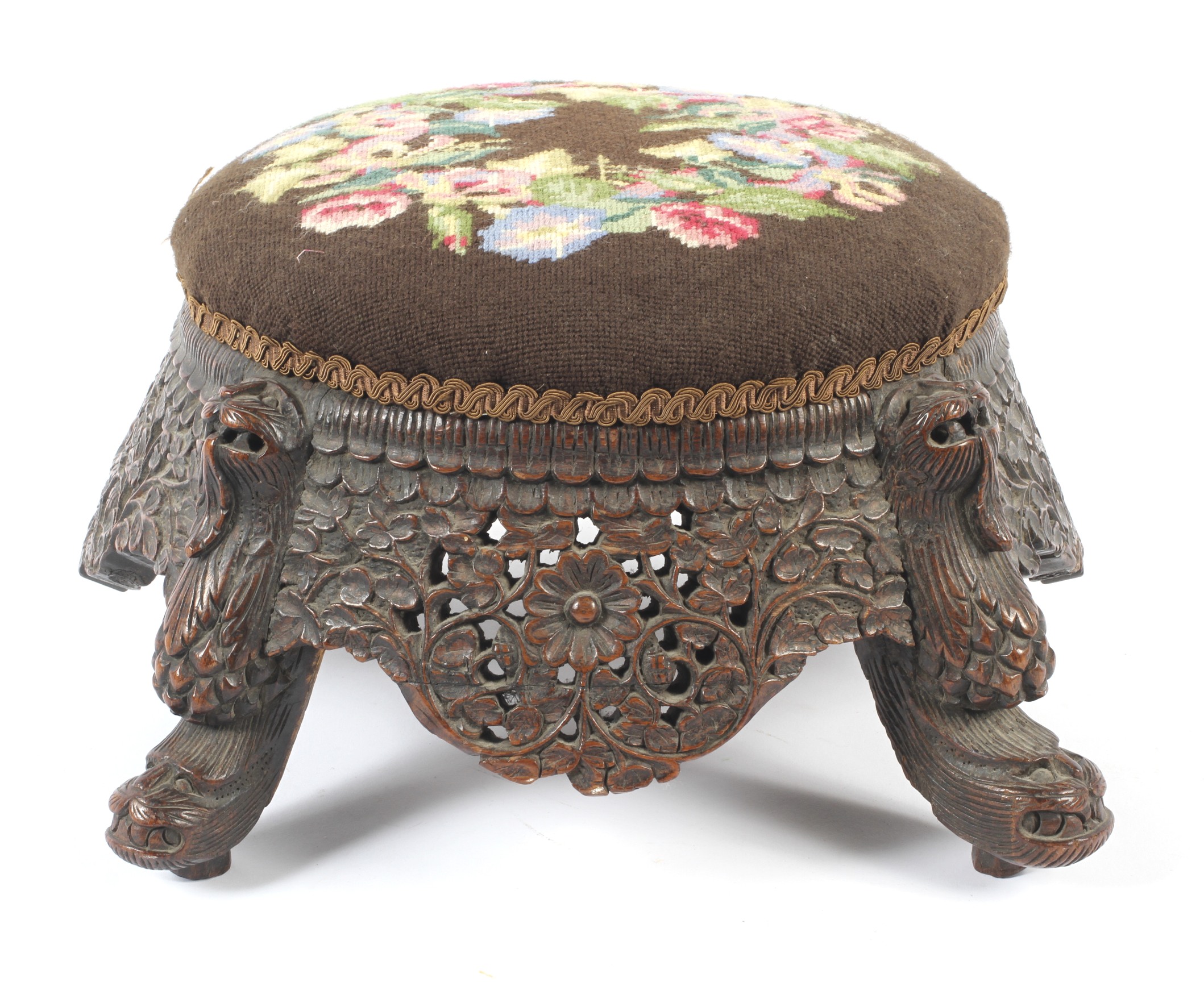 A carved hardwood Anglo-Indian low footstool.