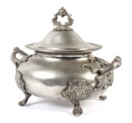 A large oval two-handled white metal tureen and cover.