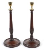 A pair of Regency style brass mounted mahogany candle sticks.