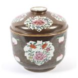 A Chinese famille rose porcelain cafe-au-lait ground jar and cover.