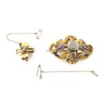 An early Victorian gold, aquamarine and amethyst three stone brooch and a four-leaf clover brooch.