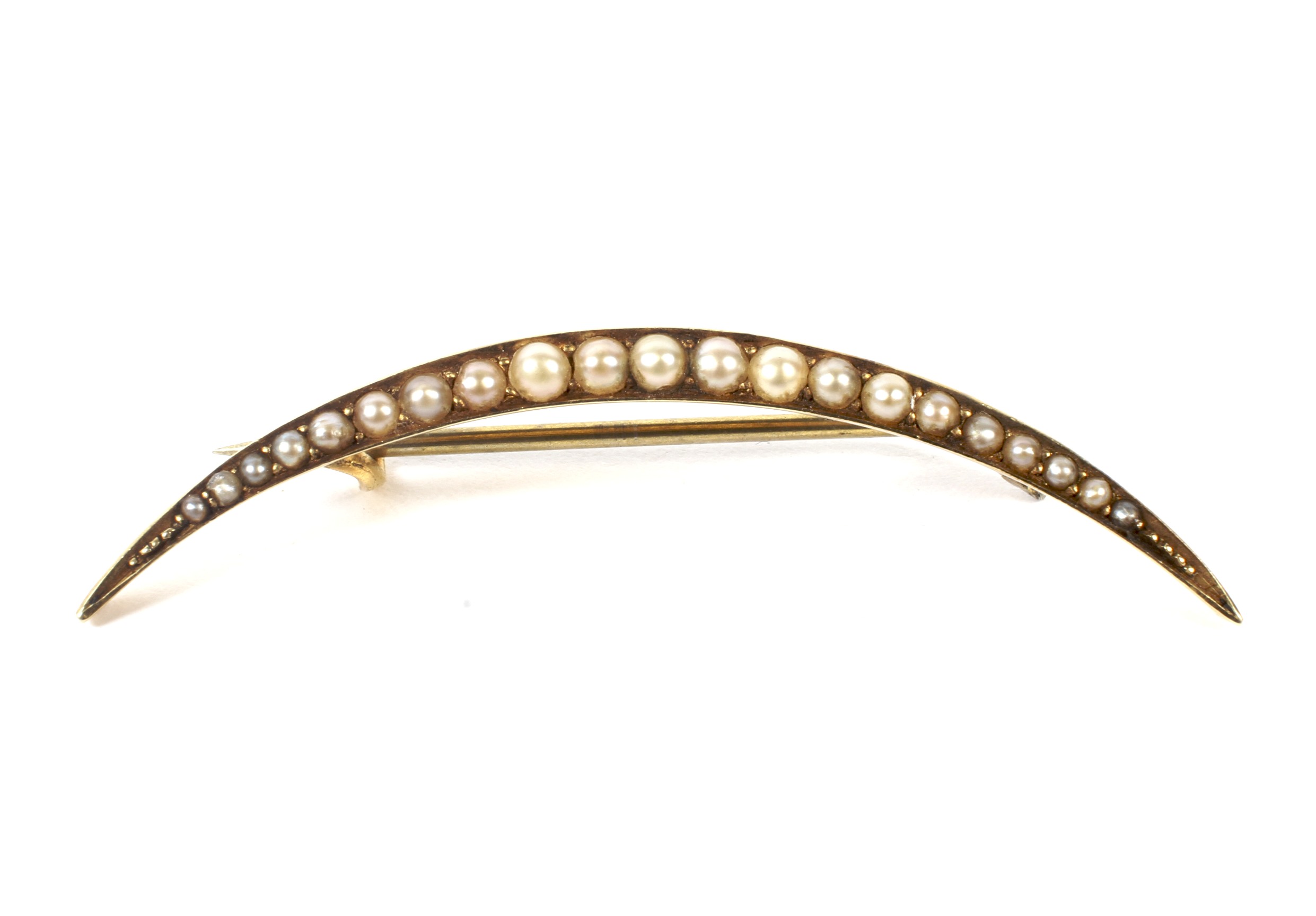 A late Victorian gold and half-pearl open crescent brooch.