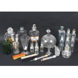 As assortment of early 20th century glass apothecary bottles and stoppers and other medical