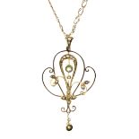 An Edwardian gold peridot and half-pearl open double-scroll pendant on a later modern double-curb