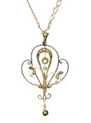 An Edwardian gold peridot and half-pearl open double-scroll pendant on a later modern double-curb