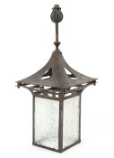An Arts and Crafts style copper and frosted glass hall lantern.
