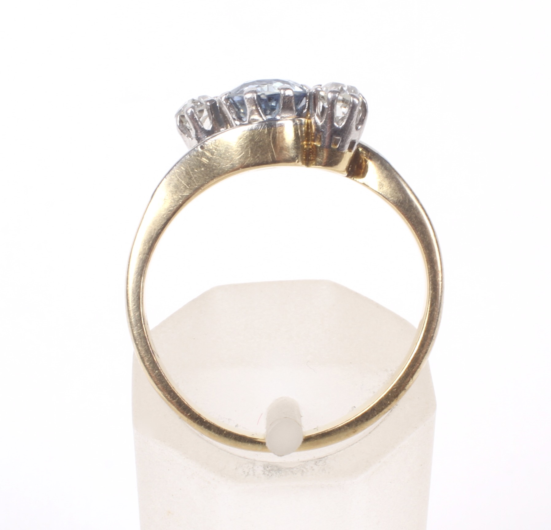 A mid 20th century gold, sapphire and diamond three stone cross-over ring. - Image 2 of 6