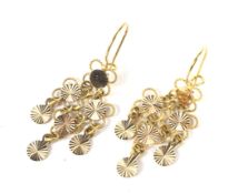 A pair of Continental yellow metal articulated open wirework and disc pendent earrings.