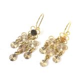 A pair of Continental yellow metal articulated open wirework and disc pendent earrings.