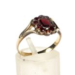 A 19th century gold-plated and red-paste oval cluster later mounted on a gold shank as a ring.