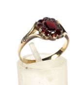 A 19th century gold-plated and red-paste oval cluster later mounted on a gold shank as a ring.