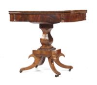 A William IV mahogany fold over tea table raised on a quatrefoil base.