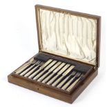 A mahogany cased twelve setting knife and fork salad/dessert set.