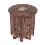 A carved teak Indian folding occasional table.