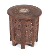 A carved teak Indian folding occasional table.