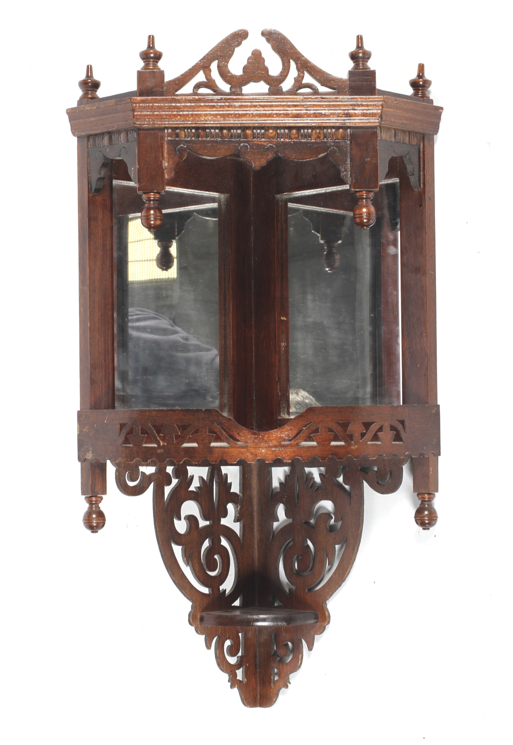 An Edwardian stained wooden hanging mirrored wall shelf.