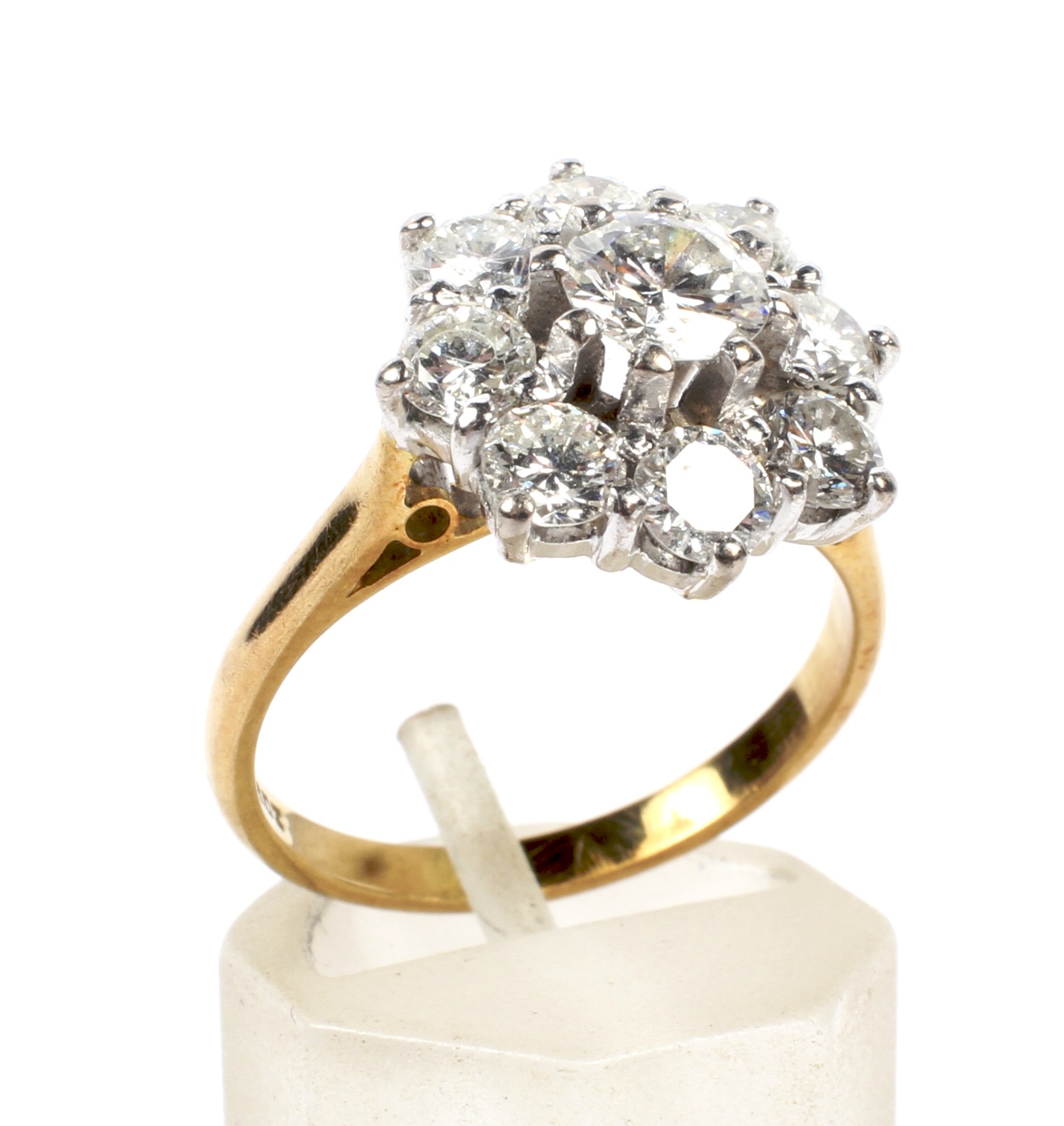 A vintage diamond nine stone cluster ring. Centred with a round brilliant diamond approx. 0.