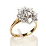 A vintage diamond nine stone cluster ring. Centred with a round brilliant diamond approx. 0.