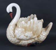 An early 20th century pottery jardiniere modelled as a swan.