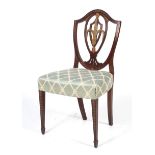 An Edwardian Hepplewhite style mahogany and inlaid shield back dining chair.