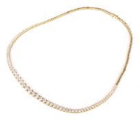 A Continental gold and diamond necklace. The 71 round brilliants graduated approx. 4.5mm-2.