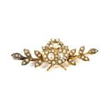 A late Victorian gold, half-pearl and diamond 'sweetheart' brooch.