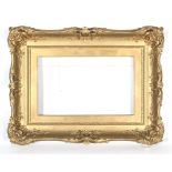 An early 20th century giltwood neo-rococo picture frame.