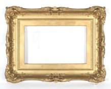 An early 20th century giltwood neo-rococo picture frame.