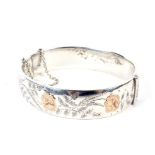 A vintage silver hollow hinged bangle.