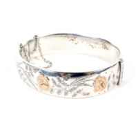 A vintage silver hollow hinged bangle.