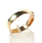 An 18ct gold flat-section wedding band. Approx 4.3mm wide, 1.