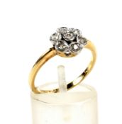 An early 20th century gold and diamond seven stone flower-head cluster ring.