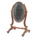 A 19th century inlaid mahogany oval shaped dressing table mirror.