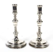 Pair of silver candlesticks with turned columns.