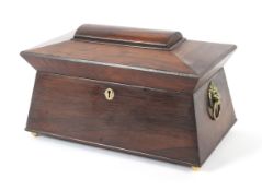 An early 19th century rosewood sarcophagus shaped tea caddy.