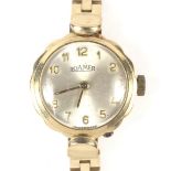 A 9ct gold ladies Roamer wrist watch with 9ct gold strap.