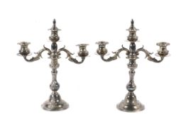 A pair of 20th century three sconce silver candelabra.