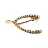 An early 20th century gold, half-pearl and diamond 'wishbone' brooch.