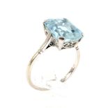 A mid-20th century platinum and aquamarine single stone ring. The emerald-cut aquamarine approx. 4.