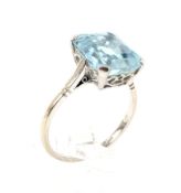 A mid-20th century platinum and aquamarine single stone ring. The emerald-cut aquamarine approx. 4.